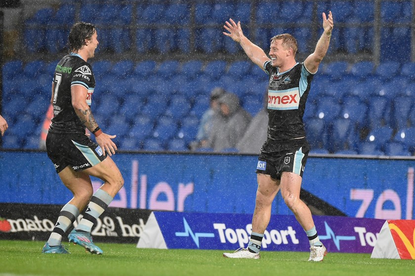 Lachlan Miller celebrates scoring a try on debut for the Sharks.