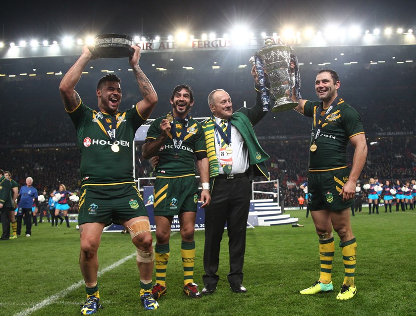 Kangaroos Andrew Fifita, Johnathan Thurston and Cameron Smith celebrate with coach Tim Sheens after the 2013 World Cup final.