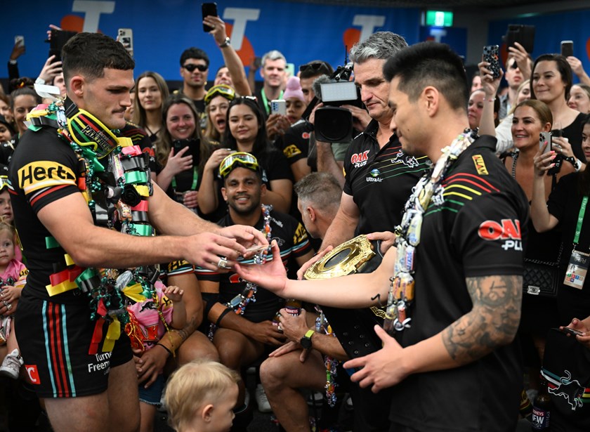 Panthers analyst Demas Wong presents Nathan Cleary with the medallion to insert in the belt