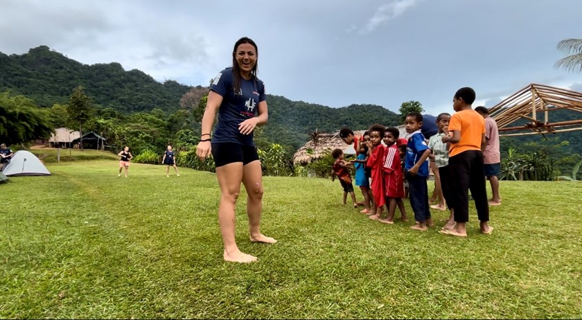 Millie Elliott with children in a village along the Kokoda Trail. 