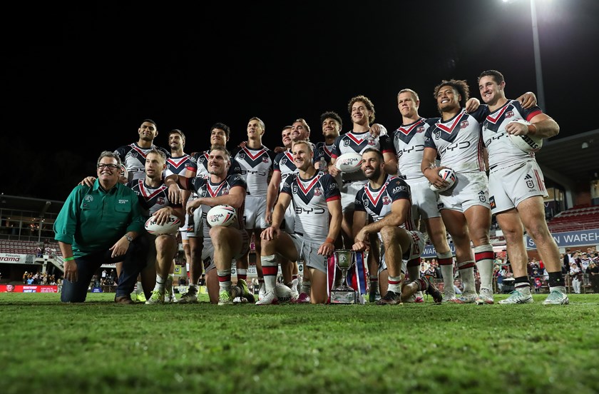 The Roosters celebrate with Gus Worland after collecting the Gotcha4Life Cup.