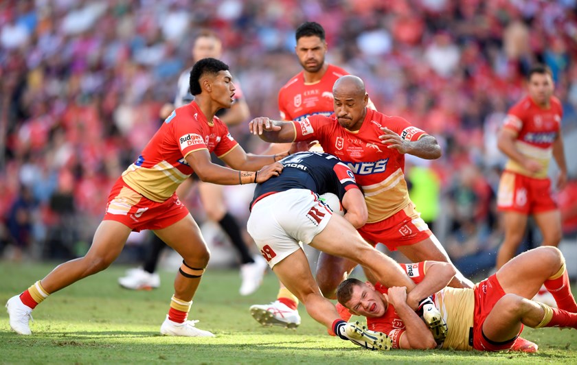 Dolphins Isaiya Katoa, Felise Kaufusi and Tom Gilbert make a tackle in their maiden NRL game in season 2023, while Jesse Bromwich looks on.