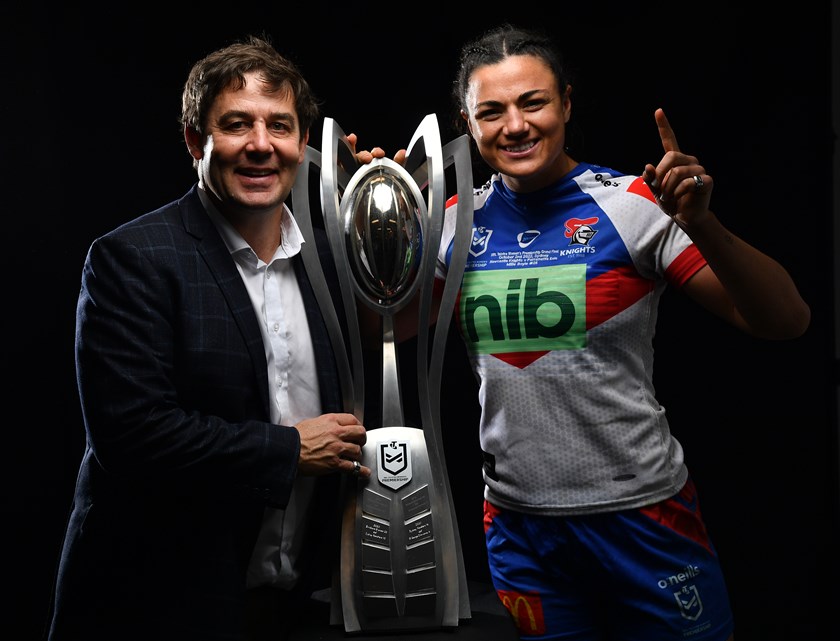 Ronnie Griffiths celebrates the Knights' 2022 NRLW title with star forward Millie Elliott.