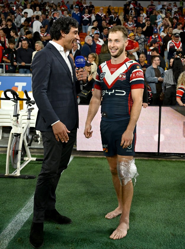 Sam Walker speaks with Johnathan Thurston post-game, with ice on his knee a precaution after making his return from injury.