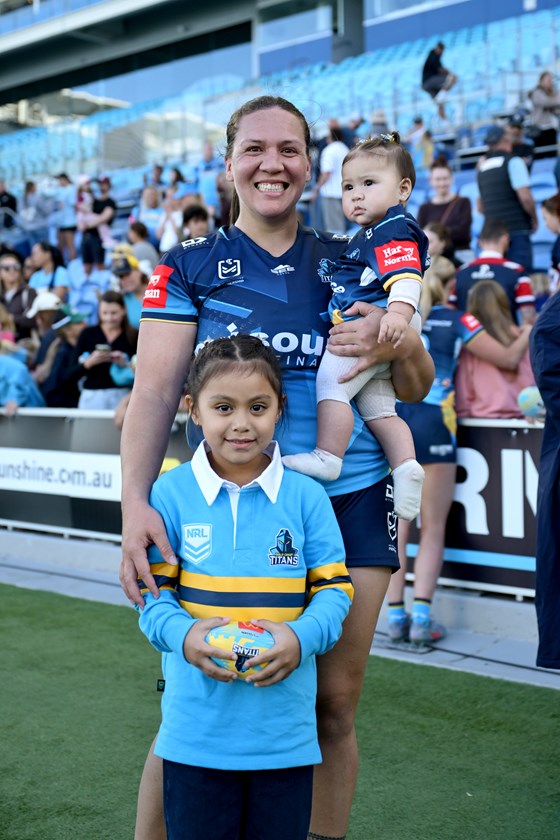 Proud mum Evania Isa’ako holding her daughter Letti after her comeback game in Round 1. 