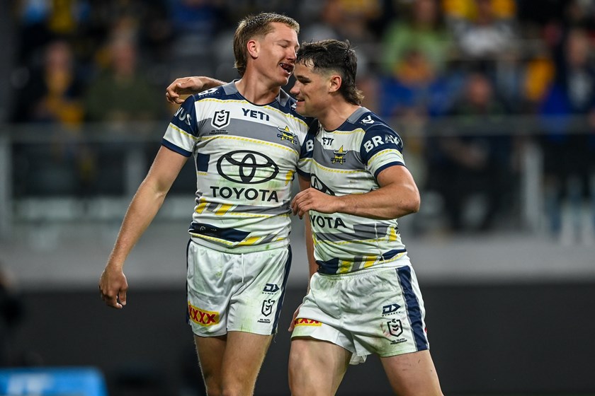 Jaxon Purdue and Tom Chester celebrate a try for the Cowboys.