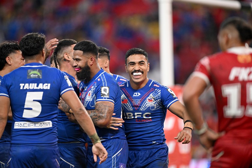 Deine Mariner and Payne Haas celebrate with Samoa.