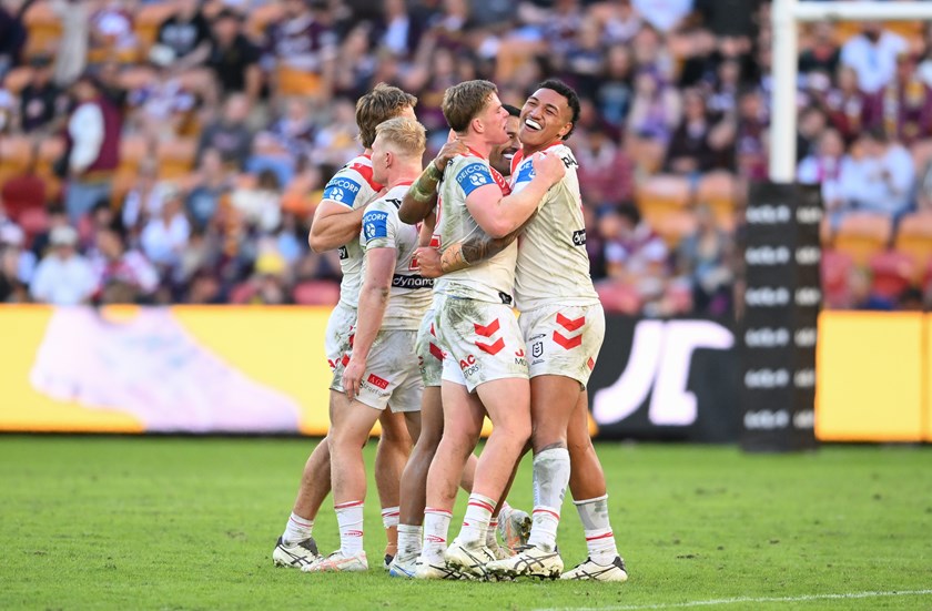 Happy Dragons forward pack celebrate their win.