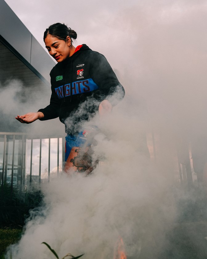 Knights NRLW and Women's Indigenous All Stars player Evah McEwen takes part in a smoking ceremony.