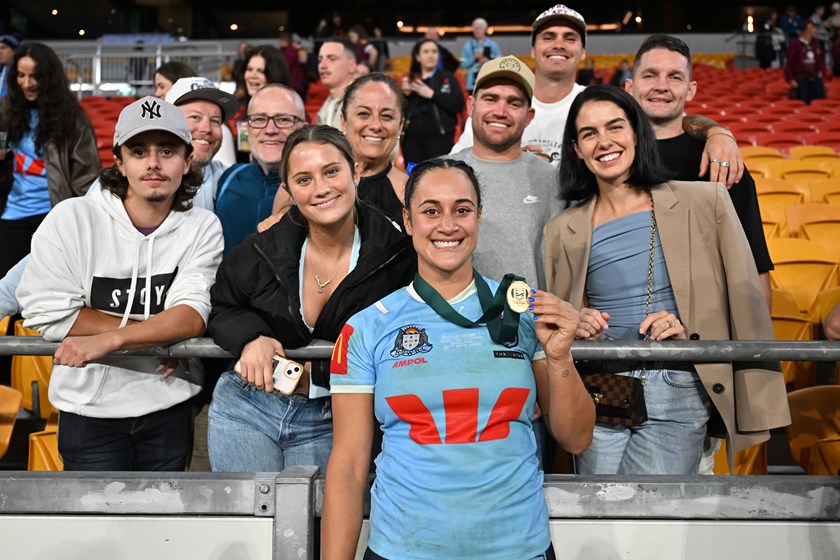 Yasmin Clydsdale with her player of the match award and supporters.
