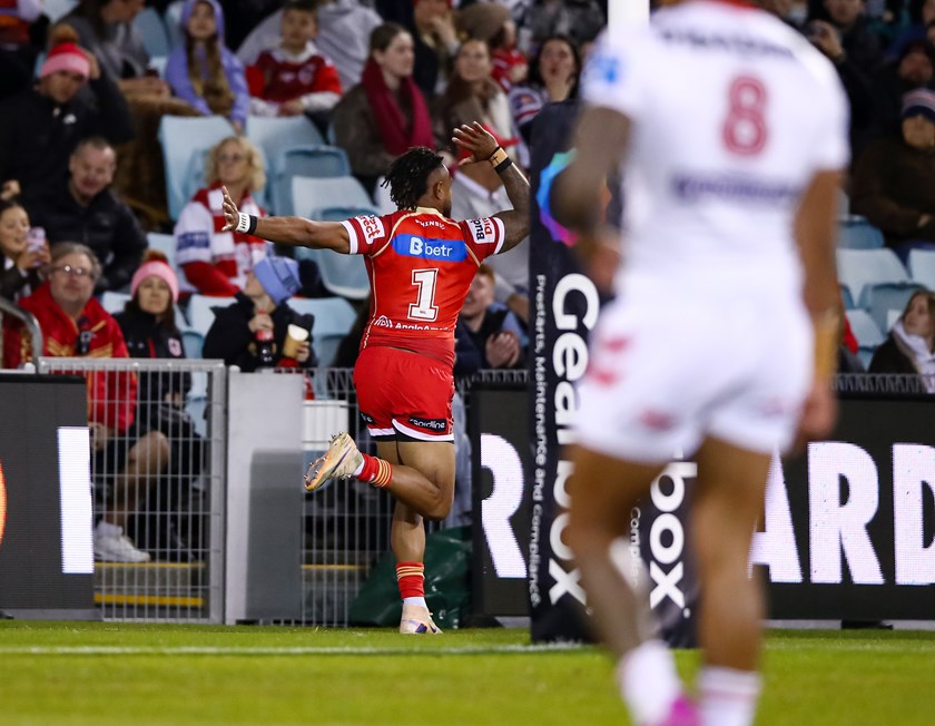 Hamiso Tabuai-Fidow does his shark totem post-try celebration after scoring against the Dragons.