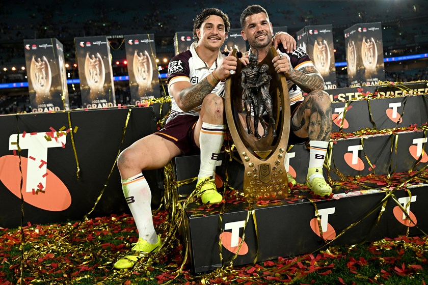 Kotoni Staggs and Adam Reynolds celebrate the 2025 grand final win.