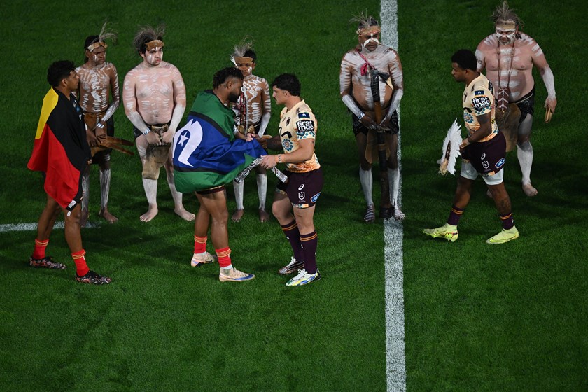 Kotoni Staggs and Hamiso Tabuai-Fidow exchange Aboriginal and Torres Strait Island gifts before last week's Indigenous Round match between the Dolphins and the Broncos.