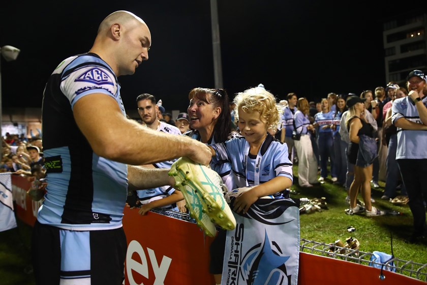 Sharks prop Tom Hazelton gifts a lucky young fan his boots after a win earlier this year.