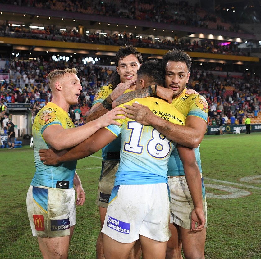 Keano Kini is mobbed by teammates after his NRL debut at Magic Round.