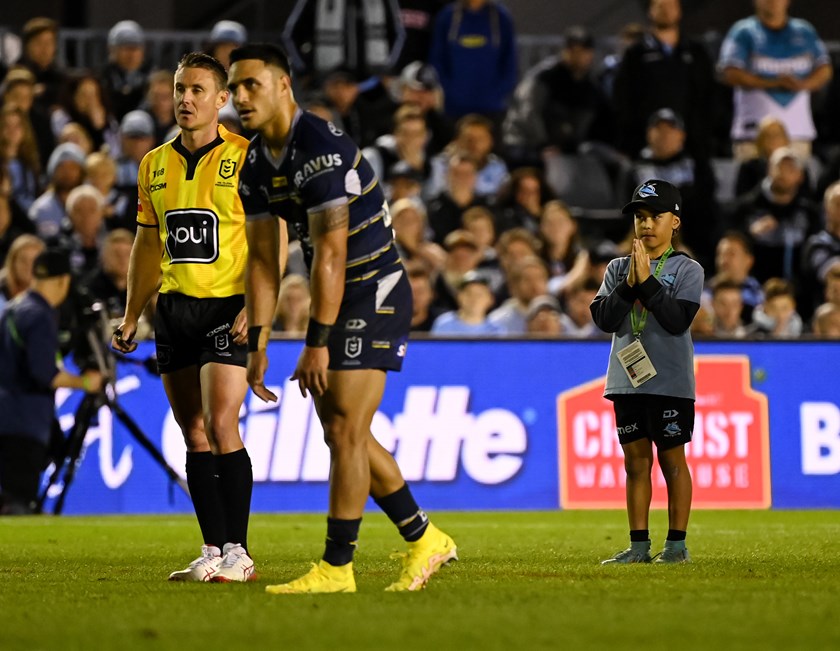 A Sharks ball kids prays for Valentine Holmes to miss his kick.
