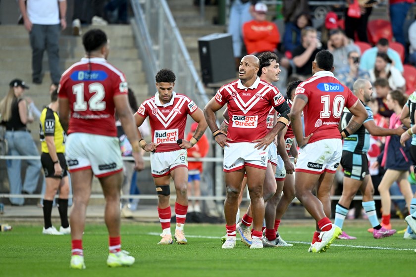 The Dolphins look dejected following a heavy loss to the Sharks.