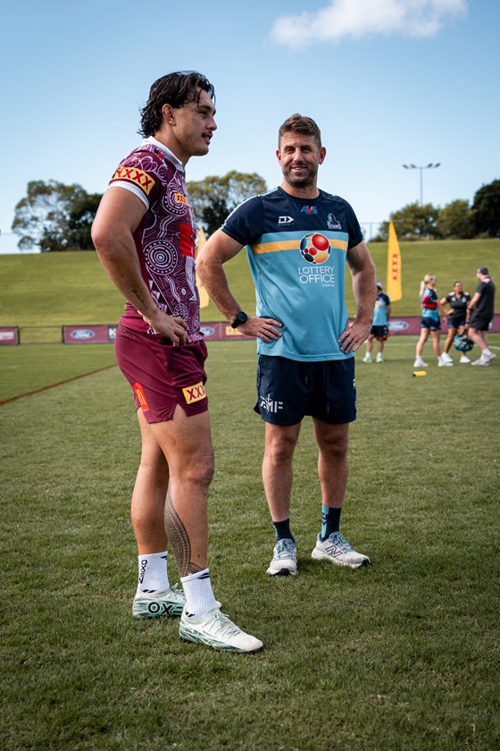 Tino Fa'asuamaleaui with his Titans coach Josh Hannay after the Gold Coast side did an opposed session with the Maroons.