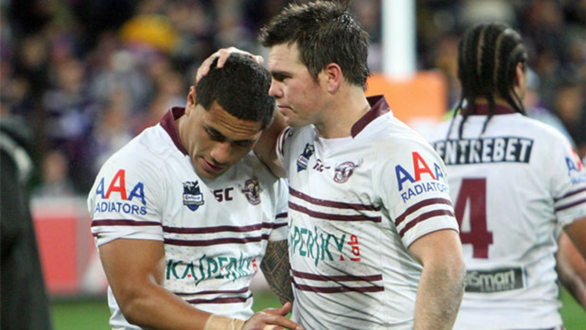 Jorge Taufua (L) and Jamie Lyon (R) console each other following Manly's preliminary final loss to Melbourne in 2012