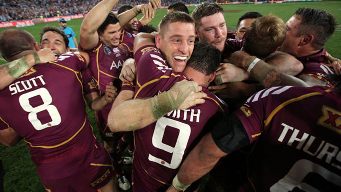 An emotional Brent Tate hugs his teammates after playing a pivotal role in Queensland’s win in Game Three; Tate has been a member of five of the Maroons’ eight straight Origin successes.