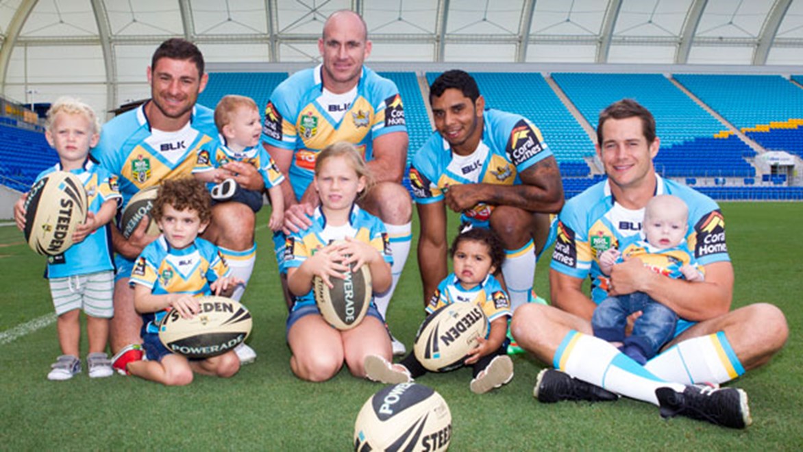 Titans players Mark Minichiello, Matthew White, Albert Kelly and Ashley Harrison aren't the only members of their family with personalised jerseys any more. Copyright: Titans Media