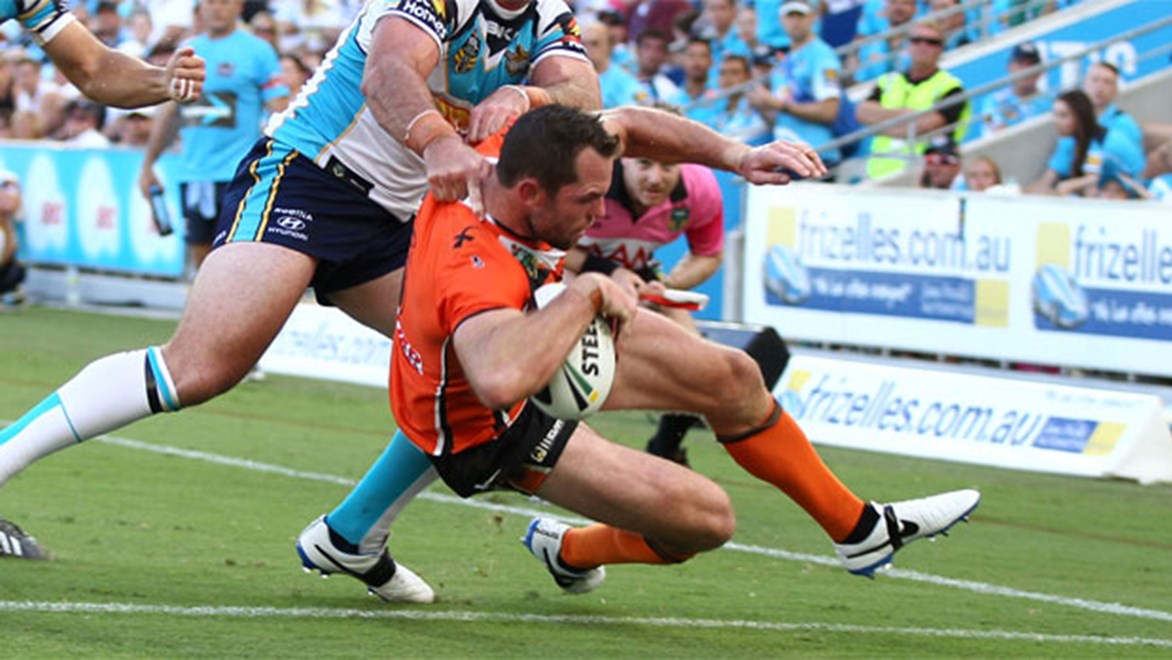 Wests Tigers winger Pat Richards scoring his second try of the afternoon against the Titans at Cbus Super Stadium. Copyright: Colin Whelan/NRL Photos.