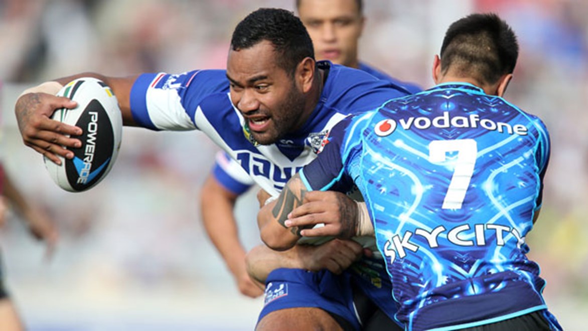 Bulldogs forward Tony Williams is wrapped up by Warriors halfback Shaun Johnson during their Sunday clash at Eden Park. Copyright: Jason Oxenham/NRL Photos