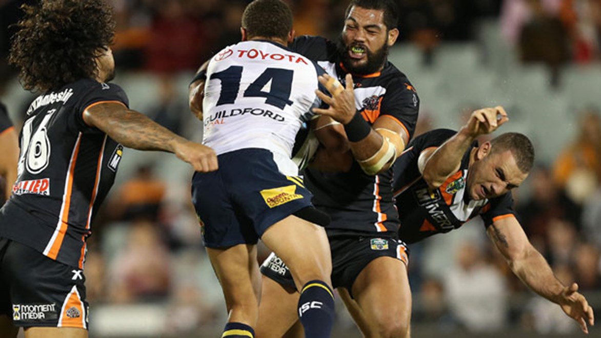 Wests Tigers captain Robbie Farah (right) is please to only be out for 4-6 weeks after dislocating his elbow in this collision against the Cowboys. Copyright: Robb Cox/NRL Photos