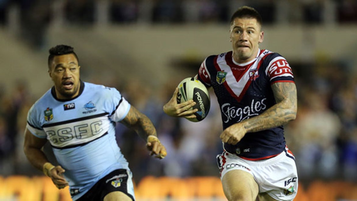 Roosters flyer Shaun Kenny-Dowall scores a runaway try, one of his two for the match, against the Sharks at Remondis Stadium on Saturday night.
