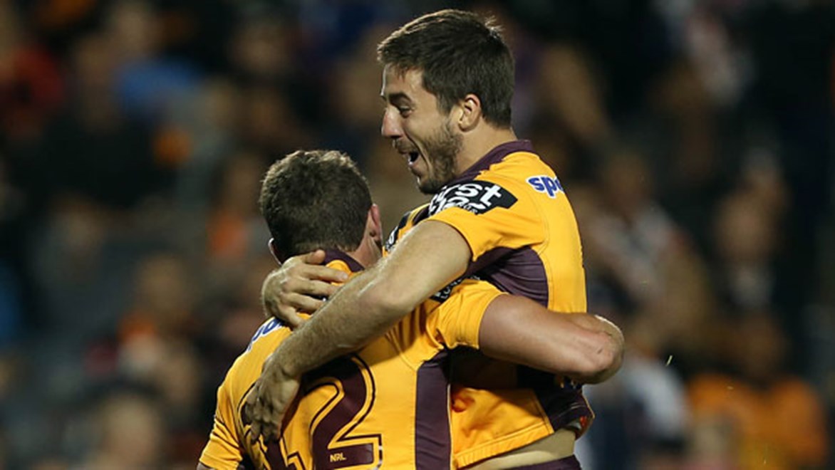 Broncos halfback Ben Hunt (right) celebrates after laying on a try for Corey Oates (right).