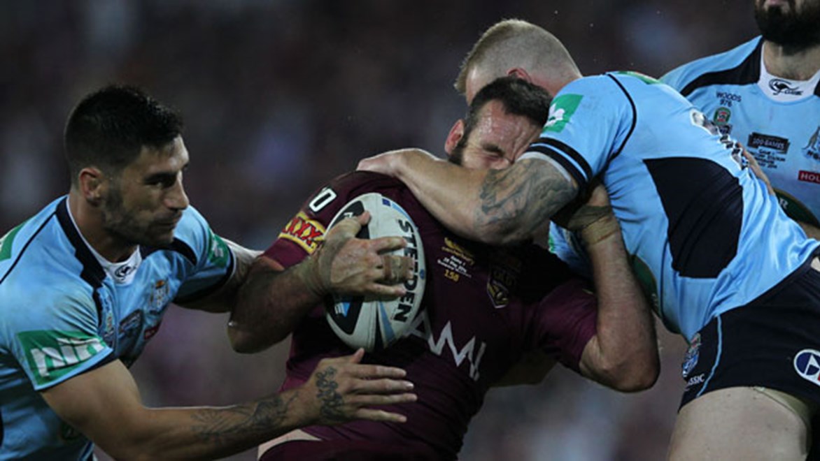 Nate Myles is subjected to some brutal Blues defence in the punishing opener to the 2014 State of Origin Series.