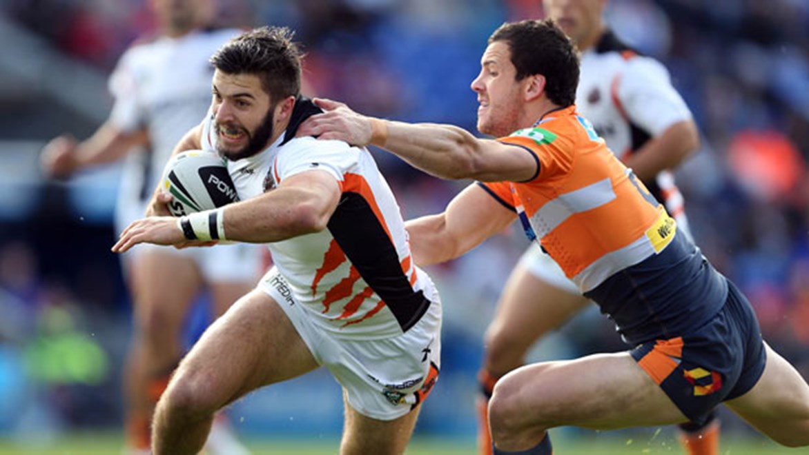 Fullback James Tedesco on his way to making 194 metres for the Wests Tigers against the Knights on Sunday.