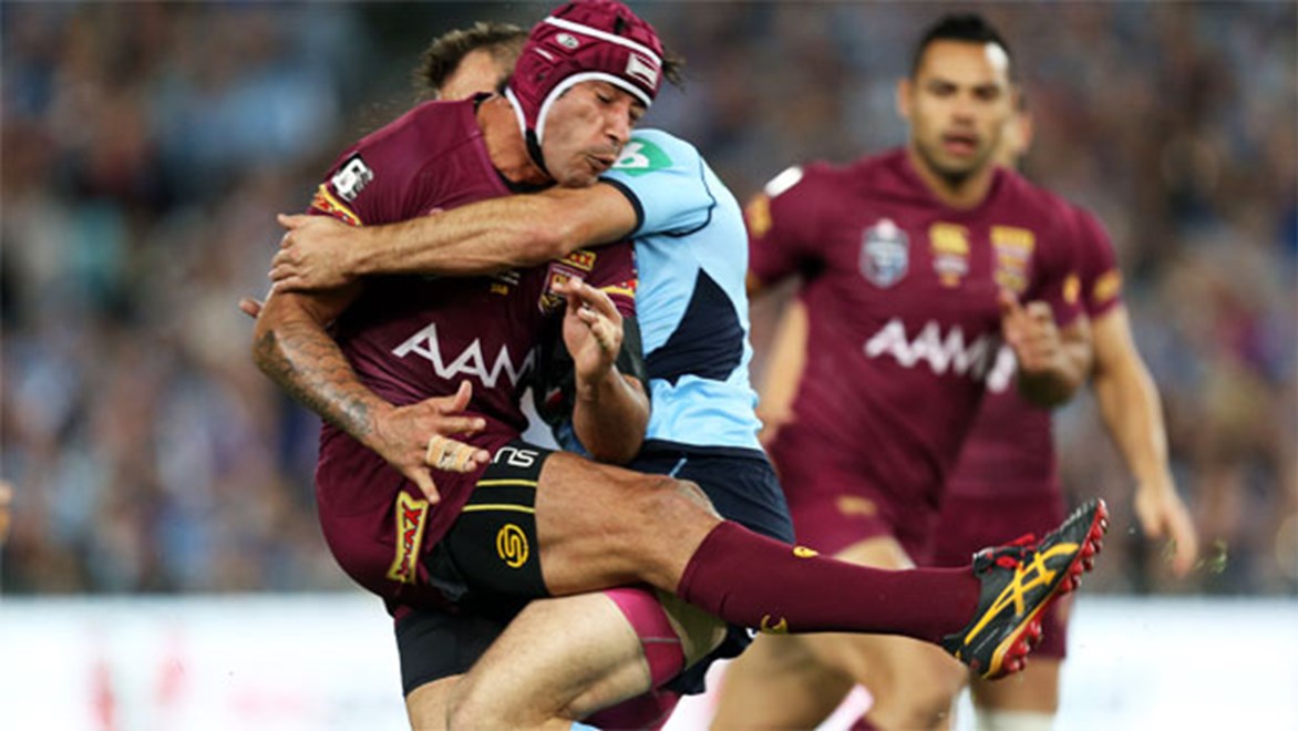 Johnathan Thurston is met by the NSW defence after getting a kick away in Origin II.