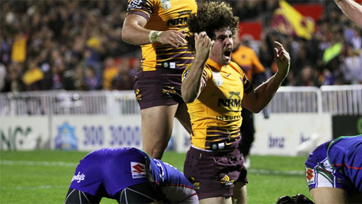 Hooker Jake Granville celebrates scoring for the Broncos against the Warriors on Saturday night.