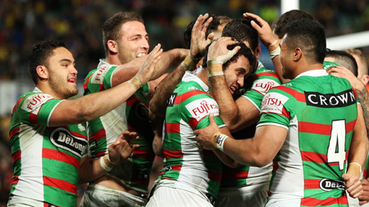 Souths players rush to congratulate Alex Johnston on his try in the Rabbitohs' 32-12 win over the Eels on Friday night.