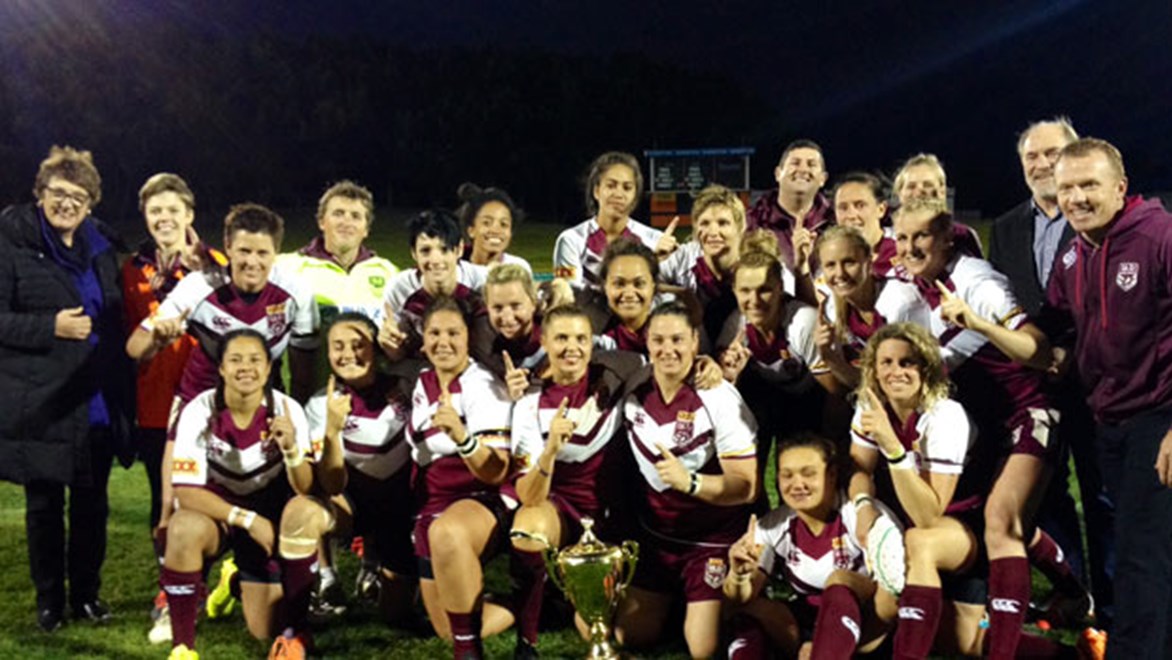 The victorious Queensland Women's side with guest ARL Commissioners Mr John Grant and Ms Cathy Harris after their victory over New South Wales at Leichhardt Oval on Saturday night.