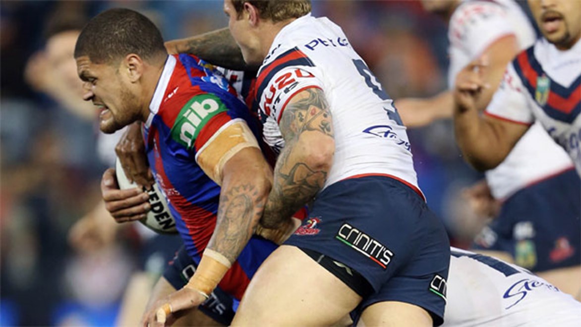 Willie Mason takes a charge for the Knights against the Roosters on Friday night.