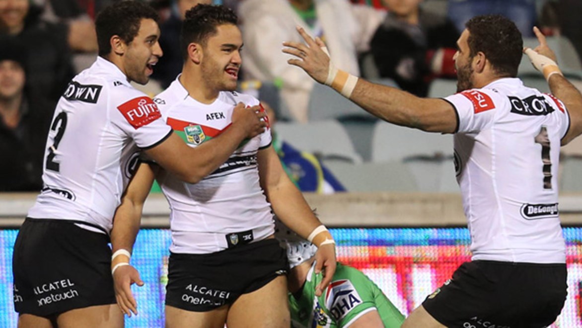 Dylan Walker and Alex Johnston celebrate with Greg Inglis during the Rabbitohs Round 20 victory over the Raiders.