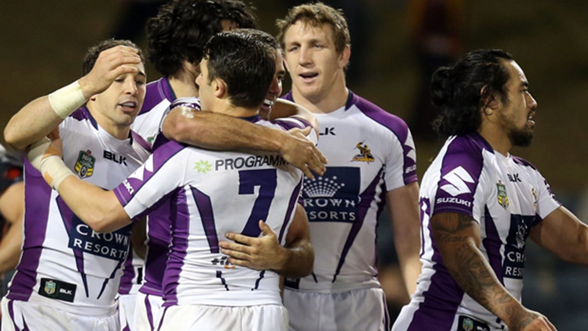 Melbourne Storm players celebrate during their Round 21 victory over Wests Tigers.