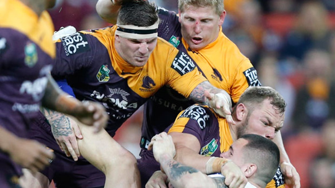 Broncos forwards Josh McGuire, Ben Hannant and Martin Kennedy dish out some heavy punishment to Bulldogs prop David Klemmer on Friday night.