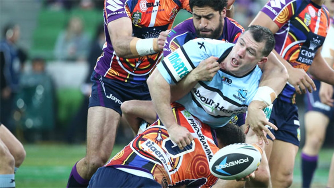 Paul Gallen gets an offload away during his return for the Sharks against Melbourne on Saturday.