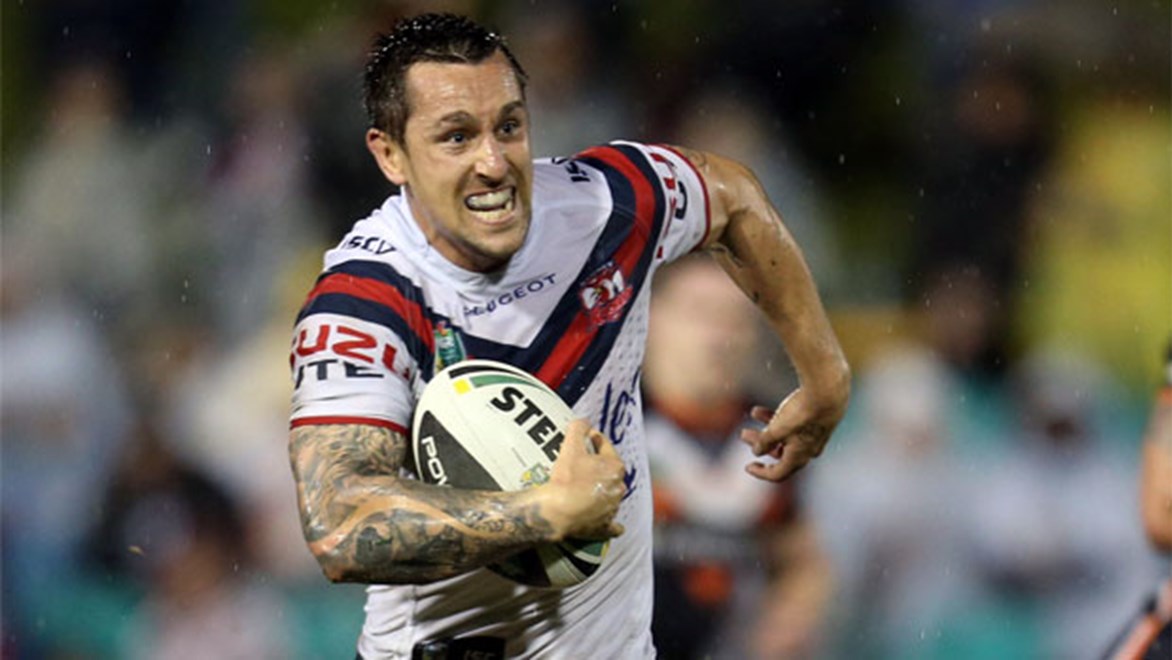 Mitchell Pearce runs clear during the Roosters' thrashing of the Wests Tigers on Saturday night.