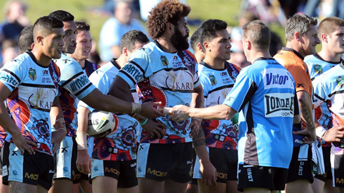 Sharks players wait to restart play in their Round 24 loss to the Raiders at Remondis Stadium.