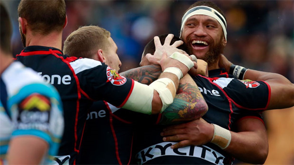 The Warriors celebrate an early try against the Titans on Sunday.