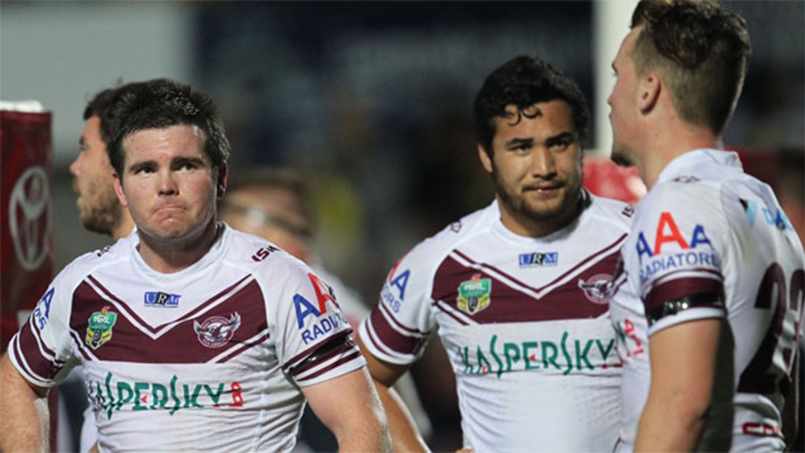 Manly players gather in the in-goal after yet another try to the Cowboys in Round 26.