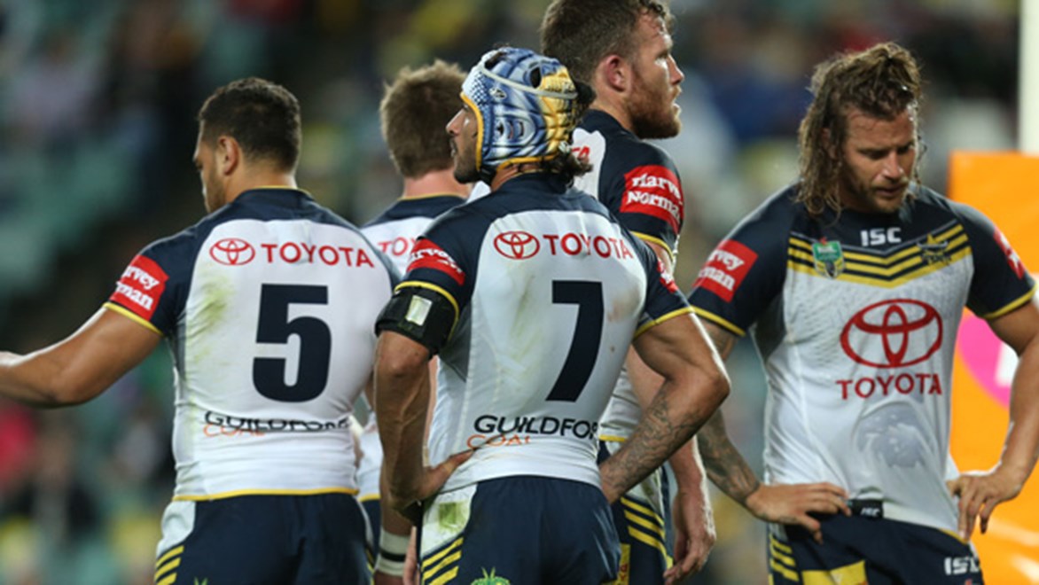 North Queensland players stand dejected following their 31-30 semi-final loss to the Roosters.