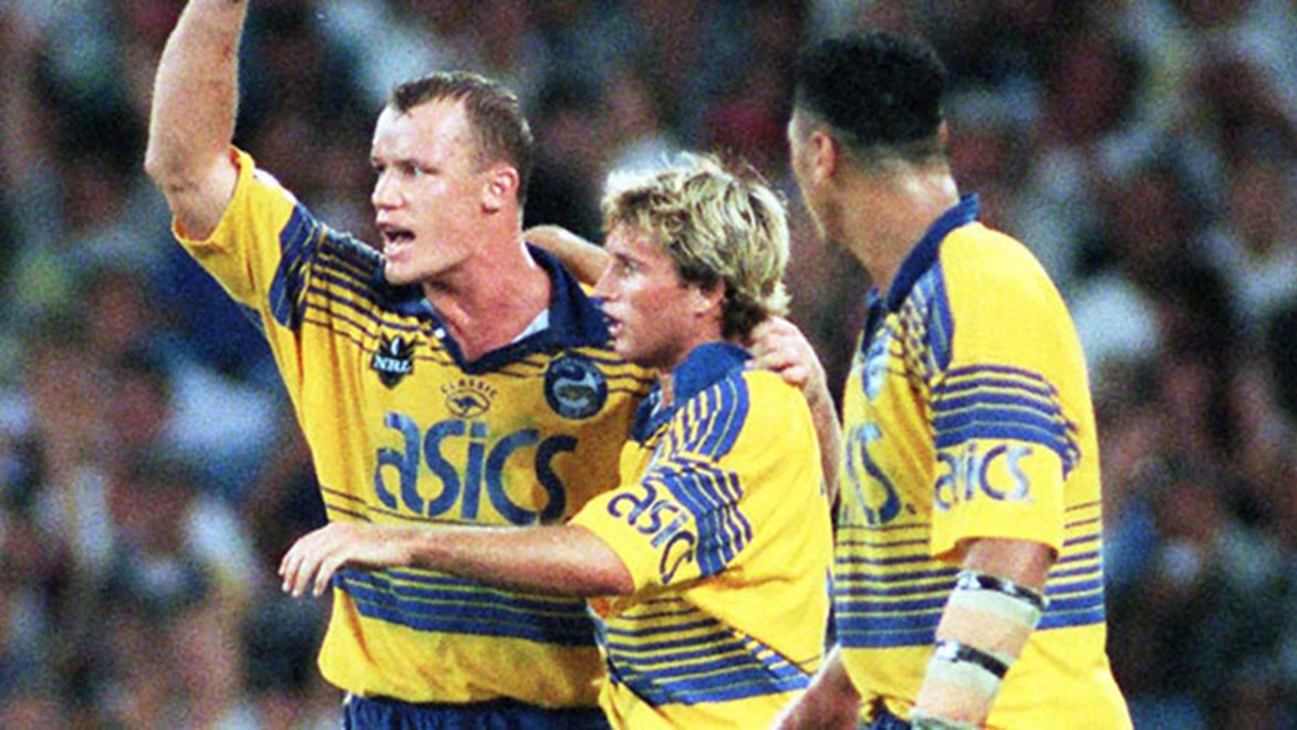 Parramatta players Jarrod McCracken, Luke Burt and David Kidwell celebrate the Eels' 20-10 defeat of St George Illawarra in front of a world record 104,583 fans at the opening of Sydney's Olympic Stadium in Round 1, 1999.