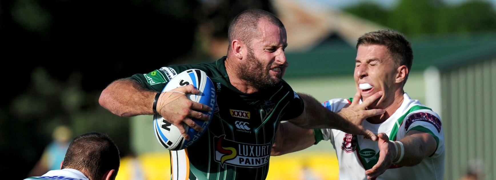 Chris Walker fends off Wynnum's Patrick Templeman in his return to top-flight rugby league with Ipswich.