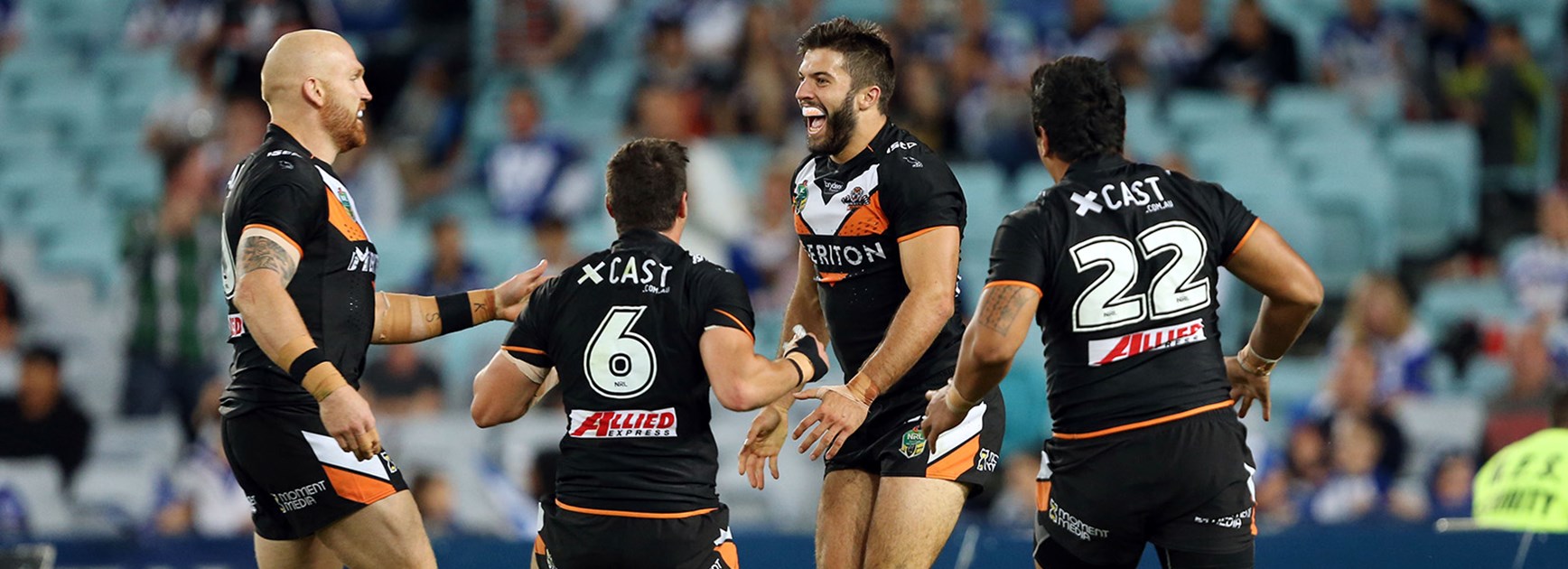 Wests Tigers celebrate a James Tedesco try against the Bulldogs in Round 4.