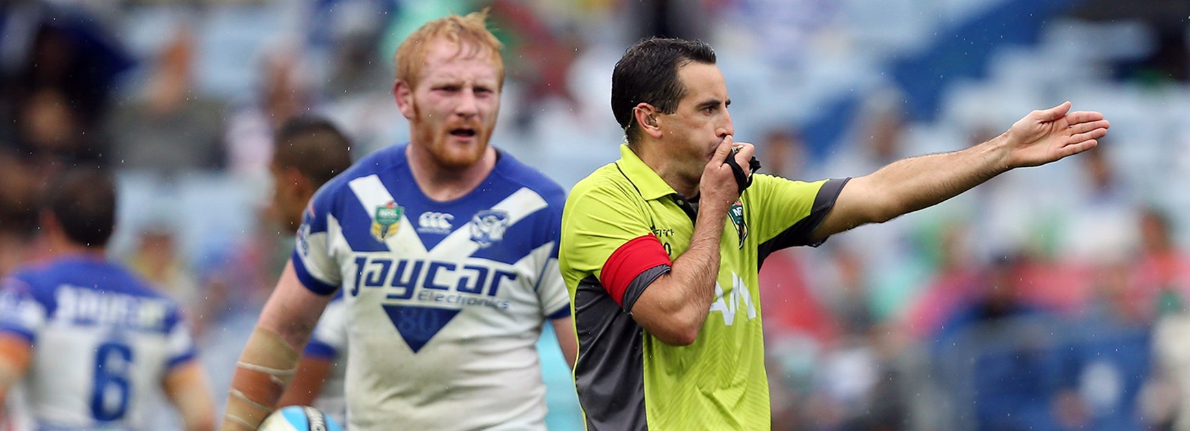 NRL referee Gerard Sutton gives a penalty to South Sydney as Canterbury captain James Graham looks on.